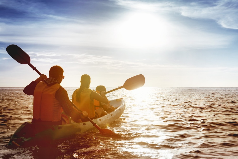 Family kayaking in the ocean