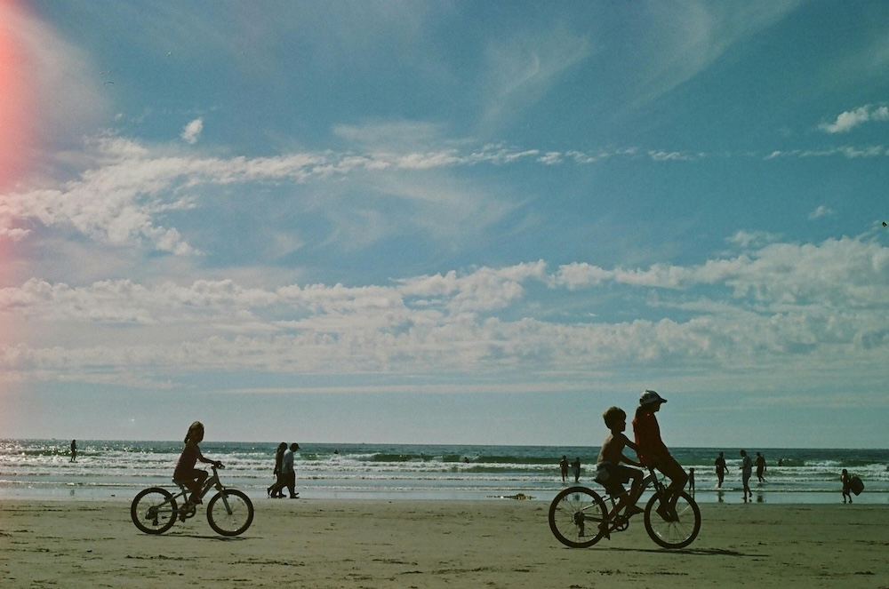 Kids biking on the beach